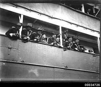 Uniformed men possibly from a military band and leaning over the ship WELLINGTON