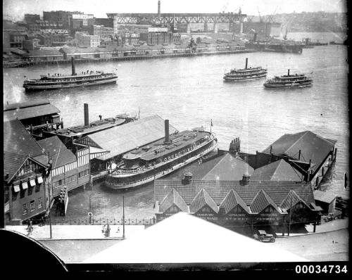 Circular Quay with view of Sydney Harbour Bridge under construction