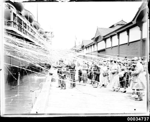 Ship departing from West Circular Quay with spectators and streamers