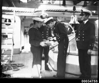 An officer tasting soup on the deck of the Chilean naval vessel GENERAL BAQUEDANO
