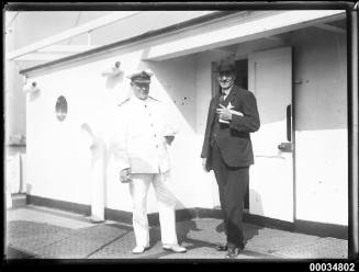 Officer and a civilian on board a ship's deck