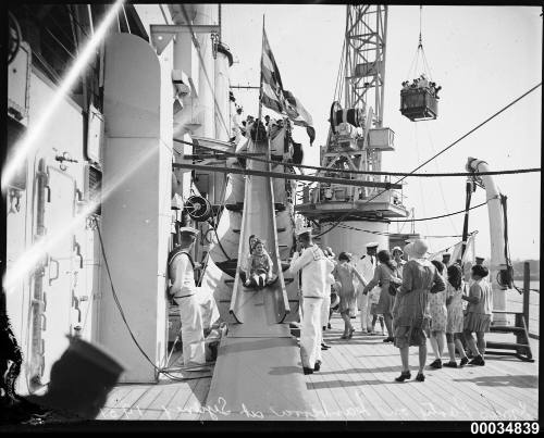 Children on a slippery slide on board HMAS AUSTRALIA II