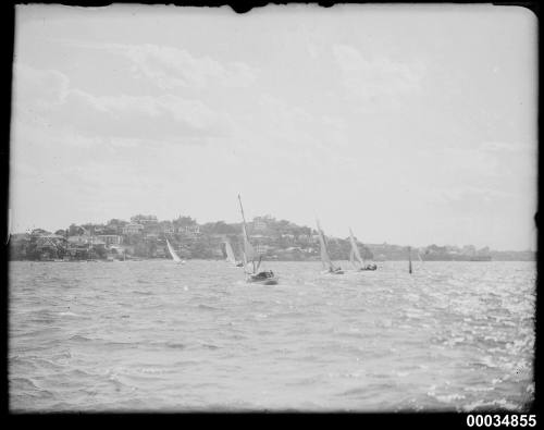 Six-metre class yachts racing on a harbour