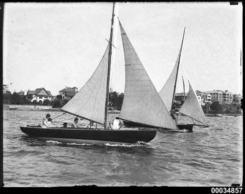 Two restricted 21-foot class yachts under sail