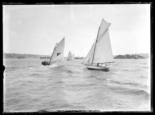 Three 18-footers approach Shark Island with an unidentified yacht closest to camera.  Inscribed 435