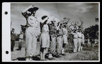 A16755 Taking the salute at the official raising of the Australian and Dutch flags at Namlea, Boeroe. Major Arnott, Brigade Major at Ambon, Lieut. Commander Whitebrook, Captain of HMAS GLENELG, Lieut. Zegers de Beul, NICA, Captain Saddlier, and Lieut. Milne. October, 1945