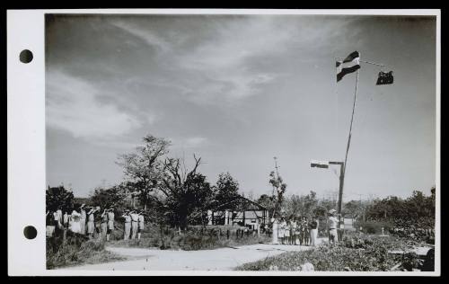 A16767 The raising of the Dutch and Australian flags at Namlea, Boeroe. October 1945