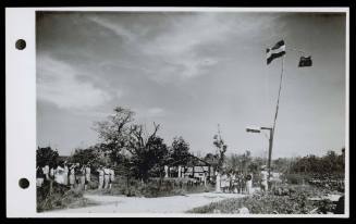 A16767 The raising of the Dutch and Australian flags at Namlea, Boeroe. October 1945
