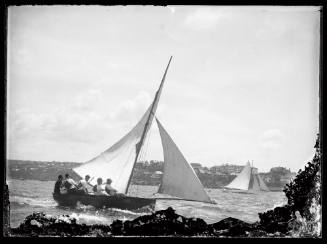 16' foot skiff on Sydney Harbour larger yacht in distance.