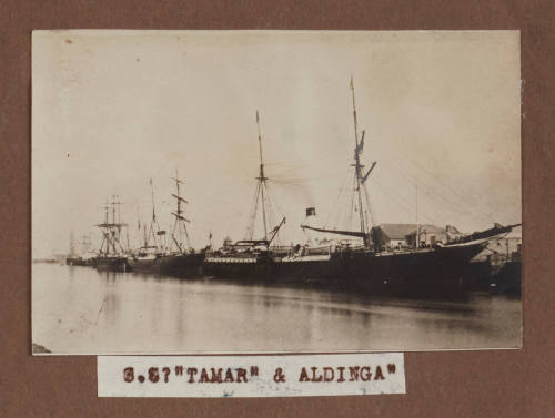 Photograph row of steam sail cargo passenger vessels berthed at wharf