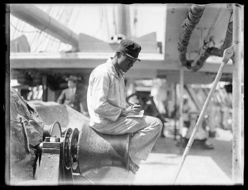 Japanese sailor sitting on a winch probably on board naval vessel TAISEI MARU