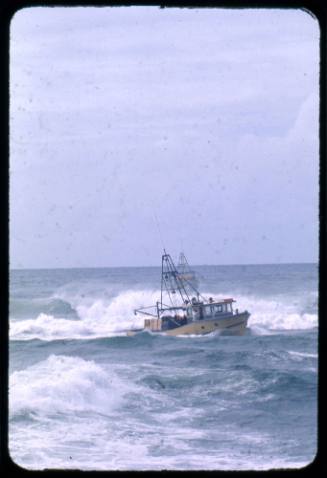 Australian fishing trawler caught in rough waters with a second trawler standing by in the distance