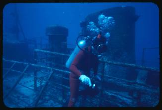 A diver exploring the wreck of a Japanese trawler in the Coral Sea