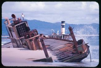 Valerie Taylor standing on the top of the wreck of a ferry at Trial Bay, New South Wales