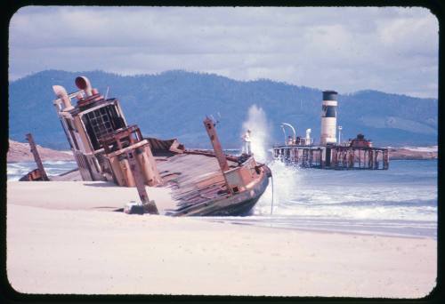 Valerie Taylor standing on a ferry wrecked at Trial Bay, New South Wales during a storm