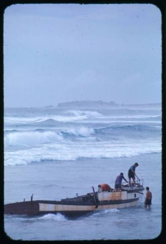 Four men and a shipwreck near shore