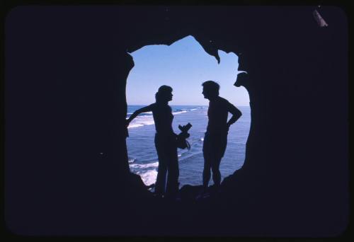 Silhouette of Valerie and Ron Taylor standing within an opening