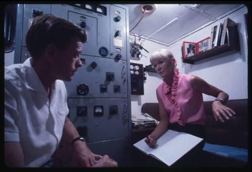 Valerie Taylor talking to a man inside a room of TERRIER VIII