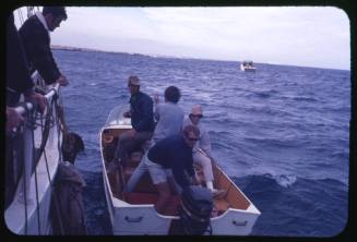 Four people including Stuart Cody on a white motorboat