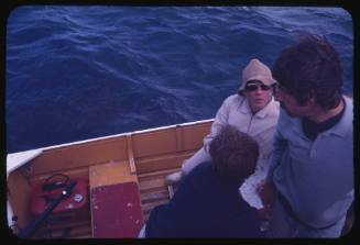 Three men on a small boat