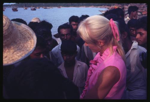 Valerie Taylor surrounded by a group of people