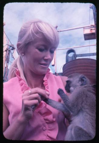 Valerie Taylor playing with a Vervet Monkey on board the Terrier VIII vessel