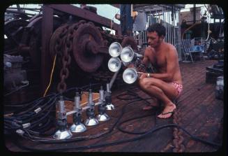 Ron Taylor holding the underwater lights used to film sharks feeding at night for the Blue Water, White Death Documentary