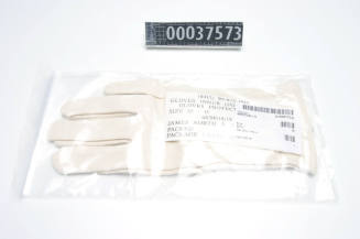 White fabric inner gloves for use with protective NBC gloves sealed in a plastic container