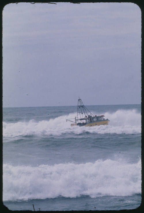 Small yellow vessel in the water