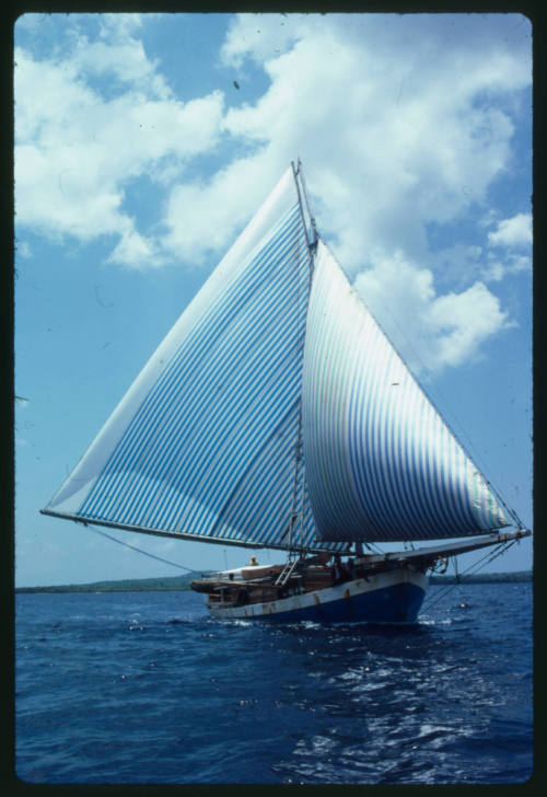 Wooden vessel with two lateen sails in the water