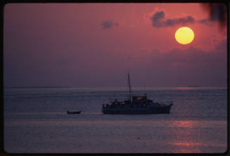 Vessel in water during sunset