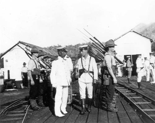 A contingent of the Australian Naval Expeditionary Force to New Guinea being inspected by a Japanese Admiral at Rabaul wharf in 1914