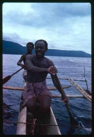 Two men on an outrigger canoe