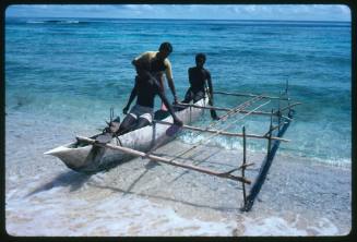 Three men on an outrigger canoe