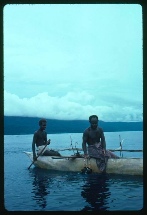 Two men on outrigger canoe