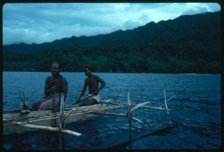 Two men on an outrigger canoe