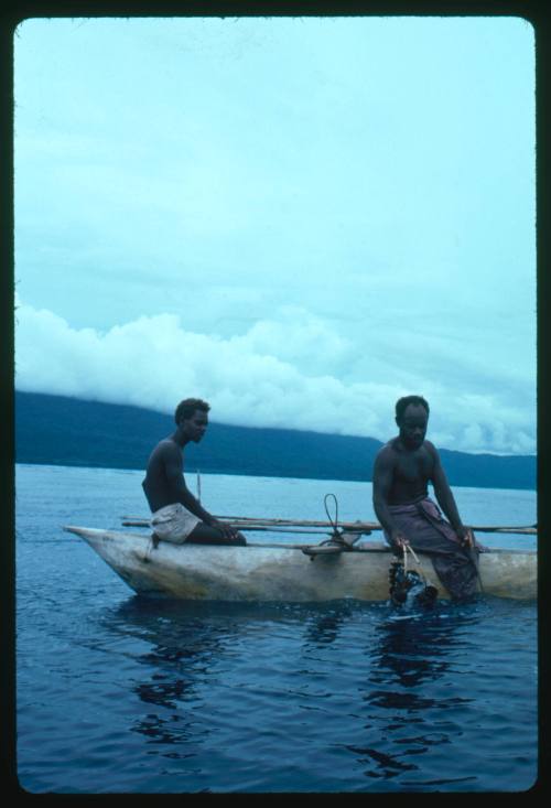 Two men on an outrigger canoe