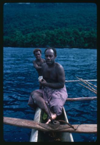 Two men on outrigger canoe