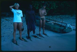 Valerie Taylor and two other men standing on beach