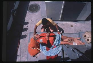 Valerie Taylor lying down on board a vessel after being attacked by a shark