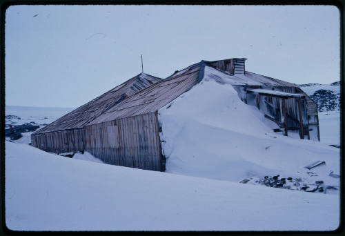 Wooden hut half buried in snow