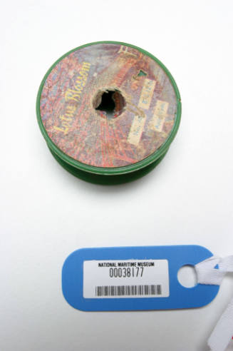 Dark green plastic spool with line wound