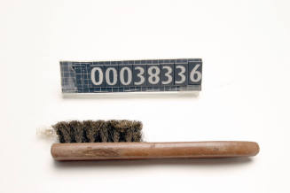 WIRE BRUSH WITH A WOODEN HANDLE USED FOR CLEANING LEAD PIPES IN SHIP BUILDING