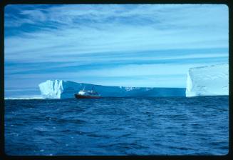 A vessel in the distance near ice shelf