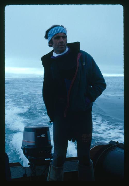 Man standing near the motor of an inflatable motor boat