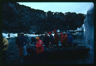 People on an inflatable motor boat near shore