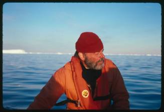 A man in a red beanie and an orange jacket