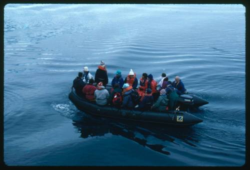 A black inflatable motorboat in the water