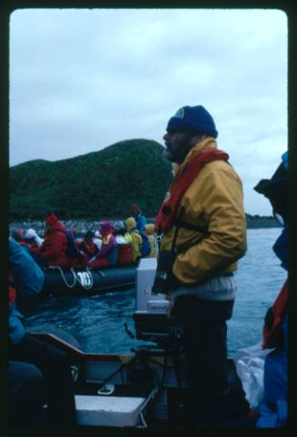 Man standing at the stern of a motorboat