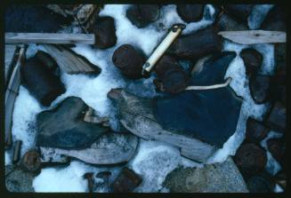 A pair of wooden shoes on a snowy surface